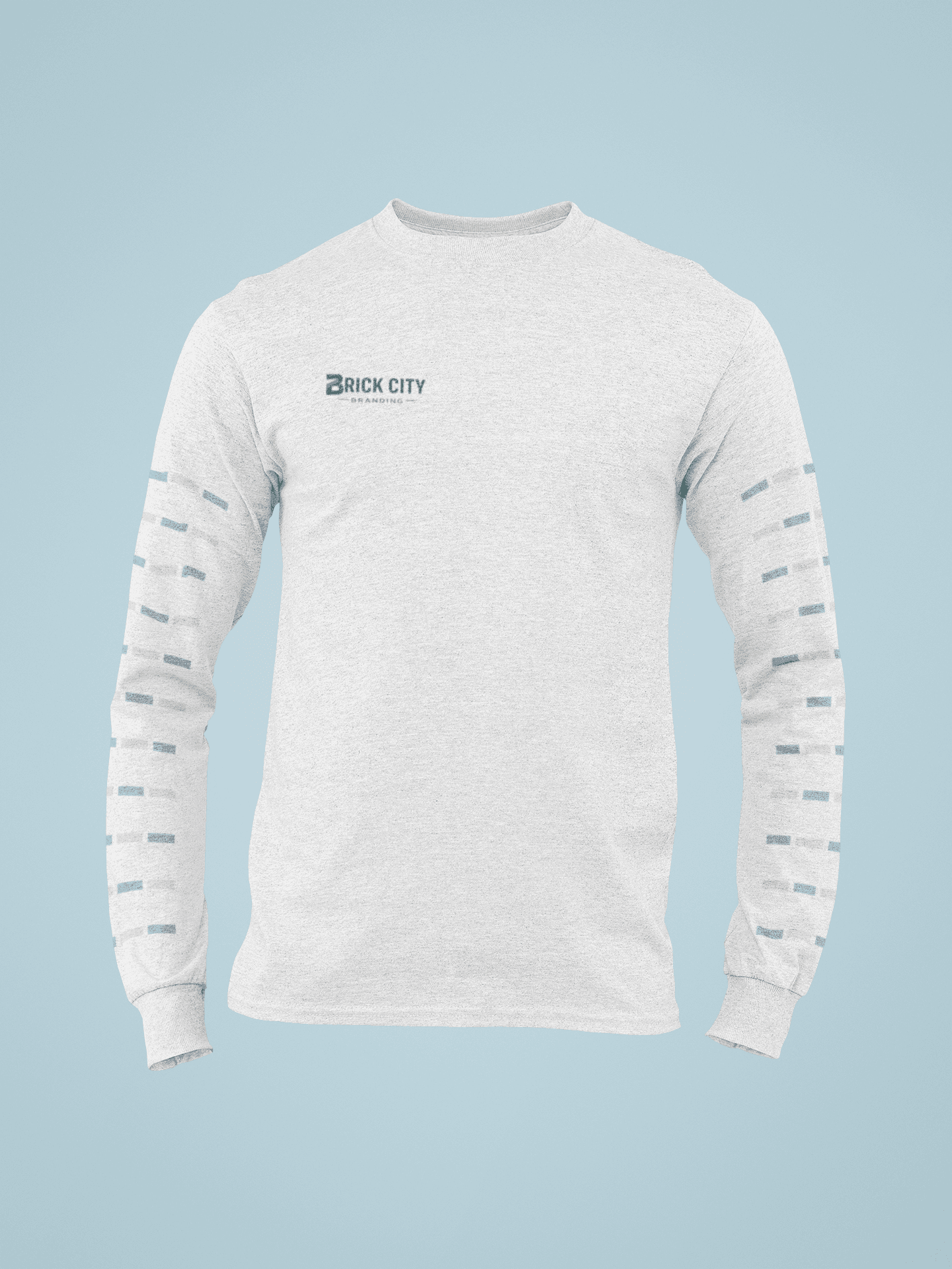 A light grey long-sleeve shirt with the Brick City Branding logo on the right chest and a repetitive teal and orange rectangular pattern printed down both sleeves.