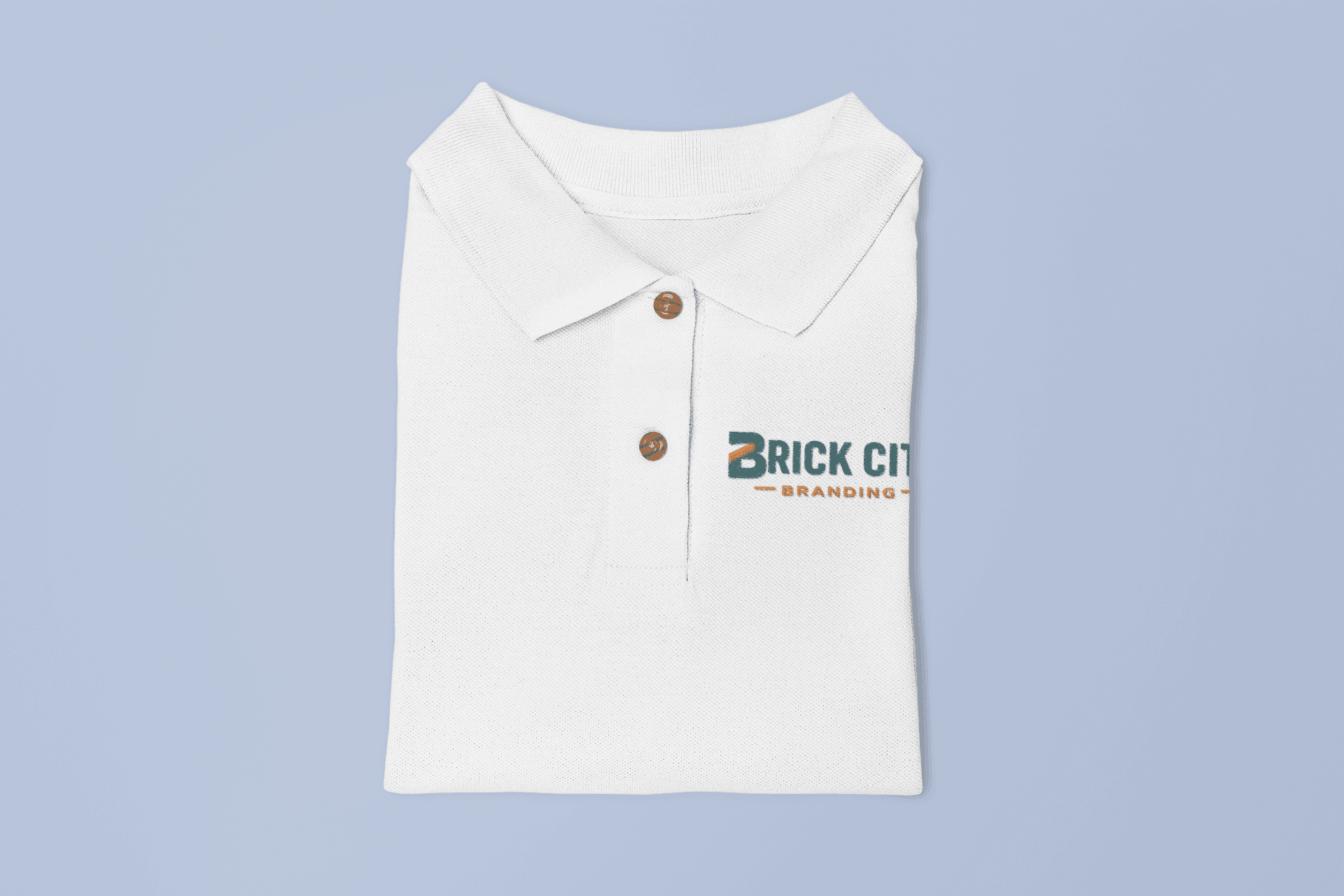 A folded white polo shirt with a high-quality multi-color embroidered 