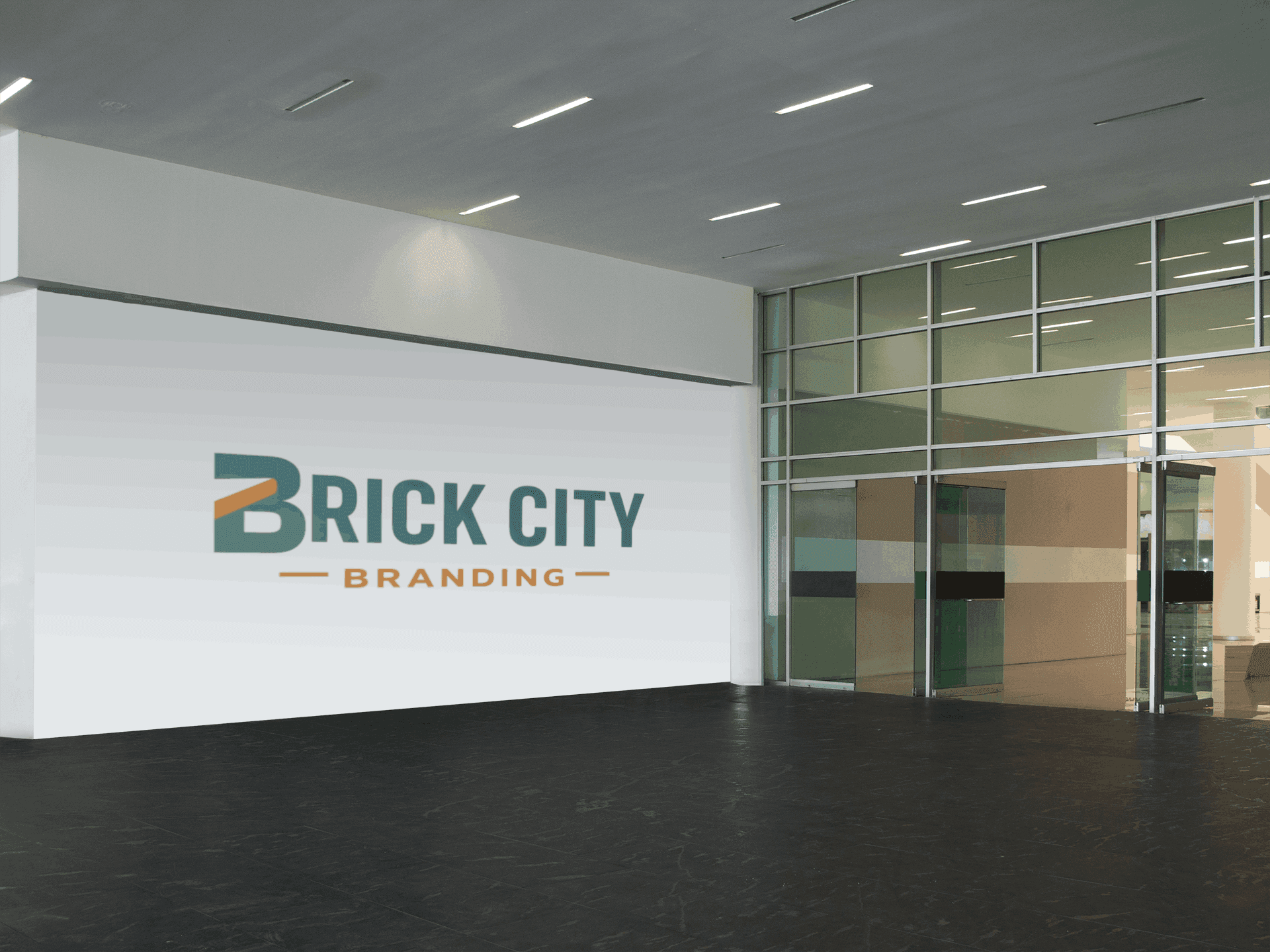 Large-scale Brick City Branding logo applied as a wall graphic in a modern glass-fronted building lobby with polished dark floors.