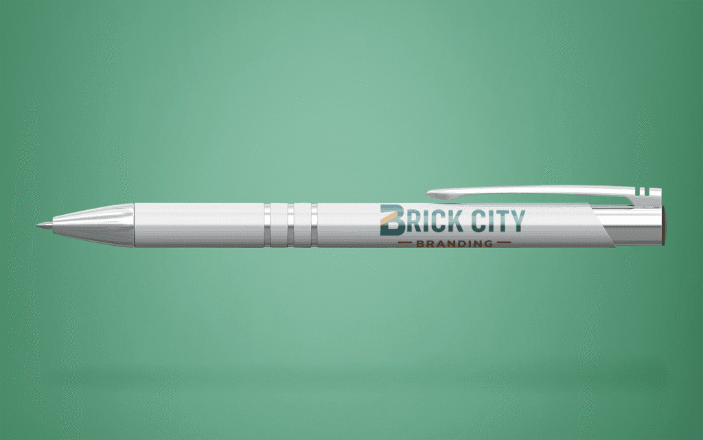 A white metal pen with a full-color Brick City Branding logo imprinted on the barrel, featuring chrome accents and a matching silver clip.