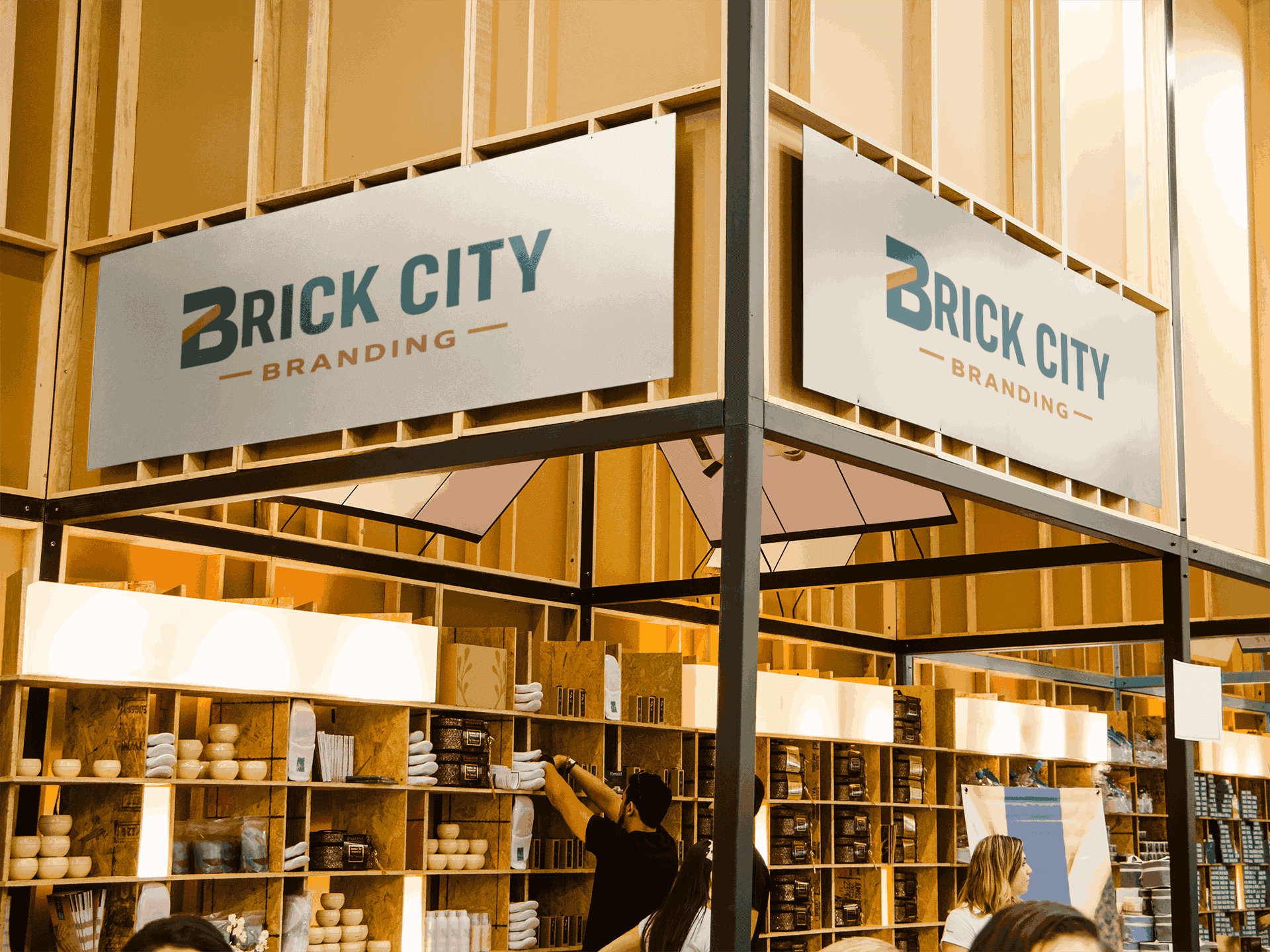 Dual overhead metal signage featuring the Brick City Branding logo mounted on a wooden frame for a professional trade show booth.