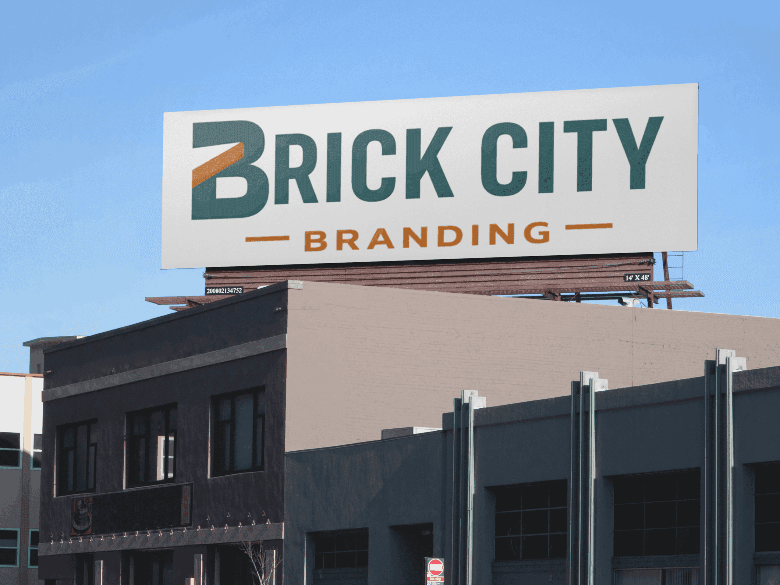 A large rectangular billboard on top of a classic brick building overlooking a city street under a bright blue sky.